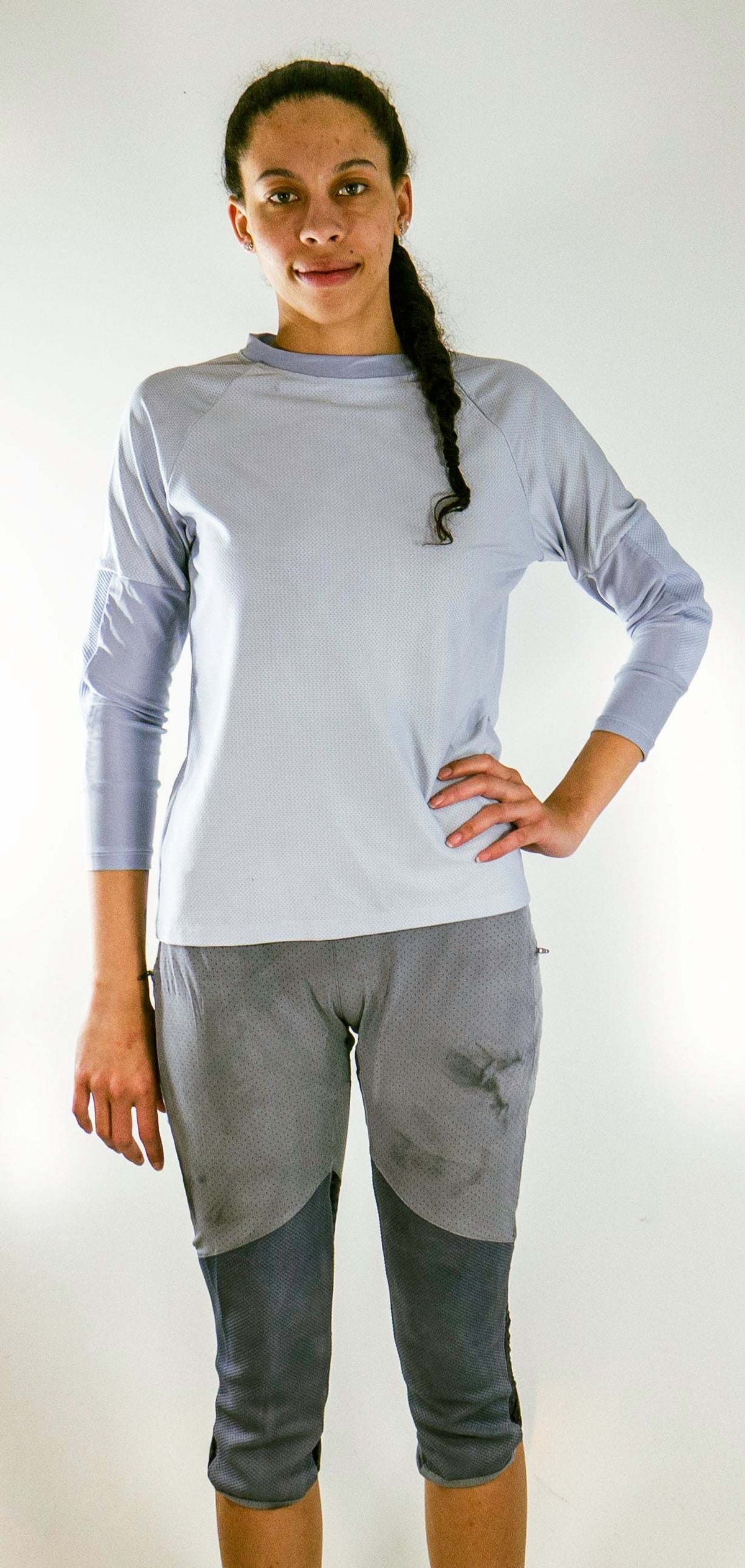 Woman wearing grey Women's Mountain Bike Pants with removable G-Form hip and knee pads and long-sleeve shirt