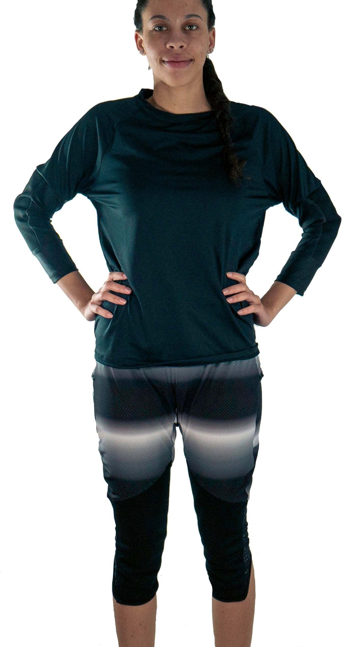 Woman wearing black long-sleeve shirt and knee-length bike pants with removable G-Form knee pads