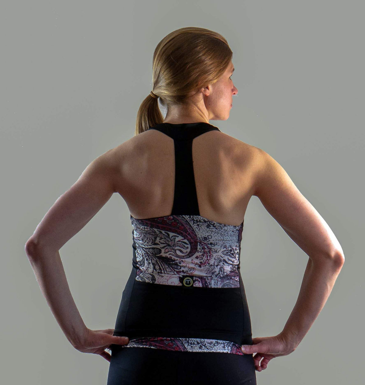 Paisley Greys sleeveless T-back top with built-in bra and roomy pockets.