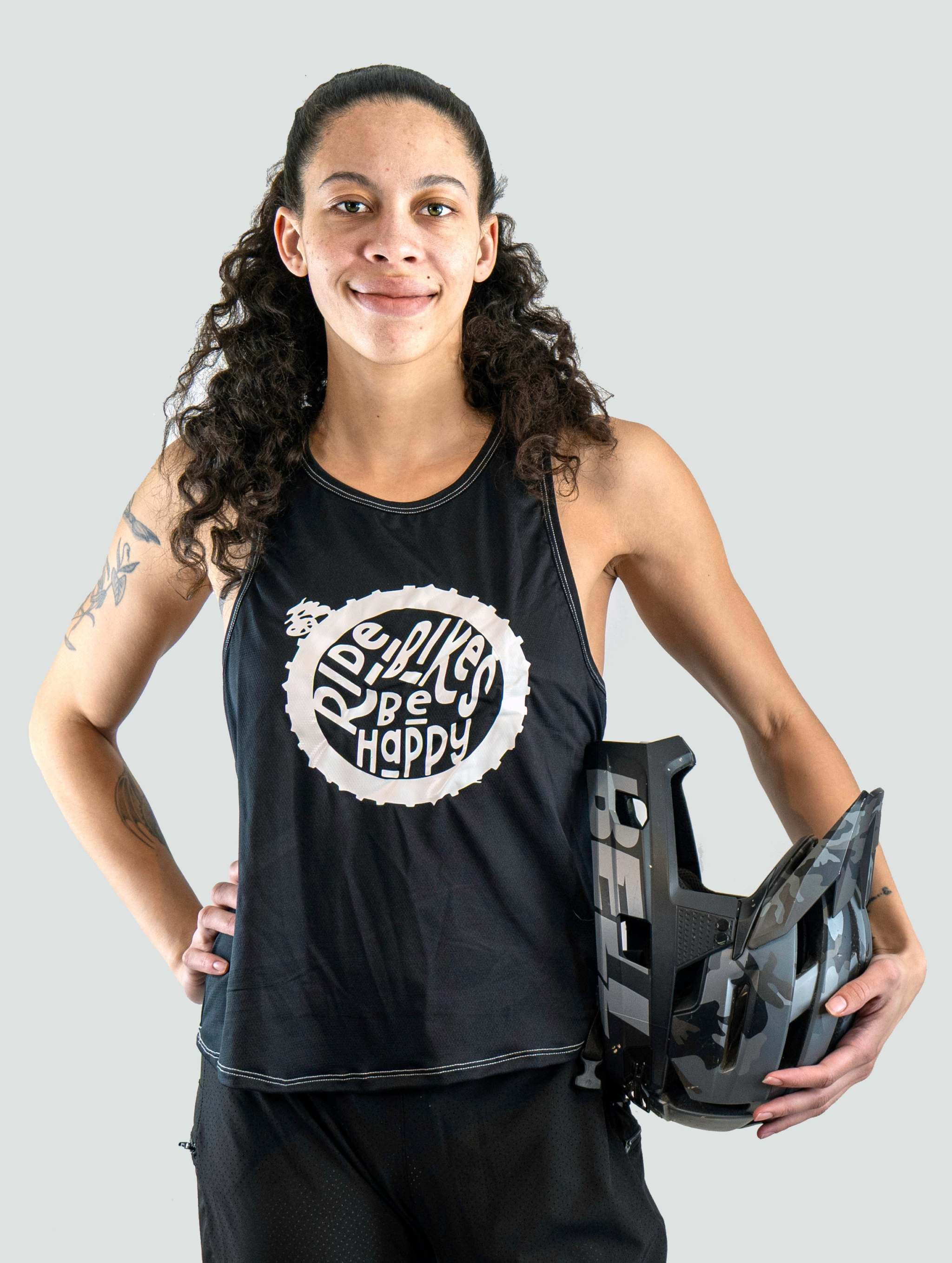 girl in a tech tank top with a mountain bike helmet