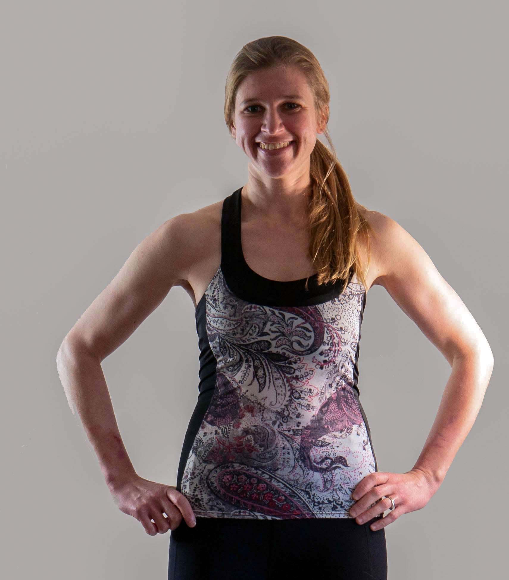Paisley Greys women's T-back top featuring lightweight, moisture-wicking fabric with ventilation ports and a built-in bra for comfort and support.