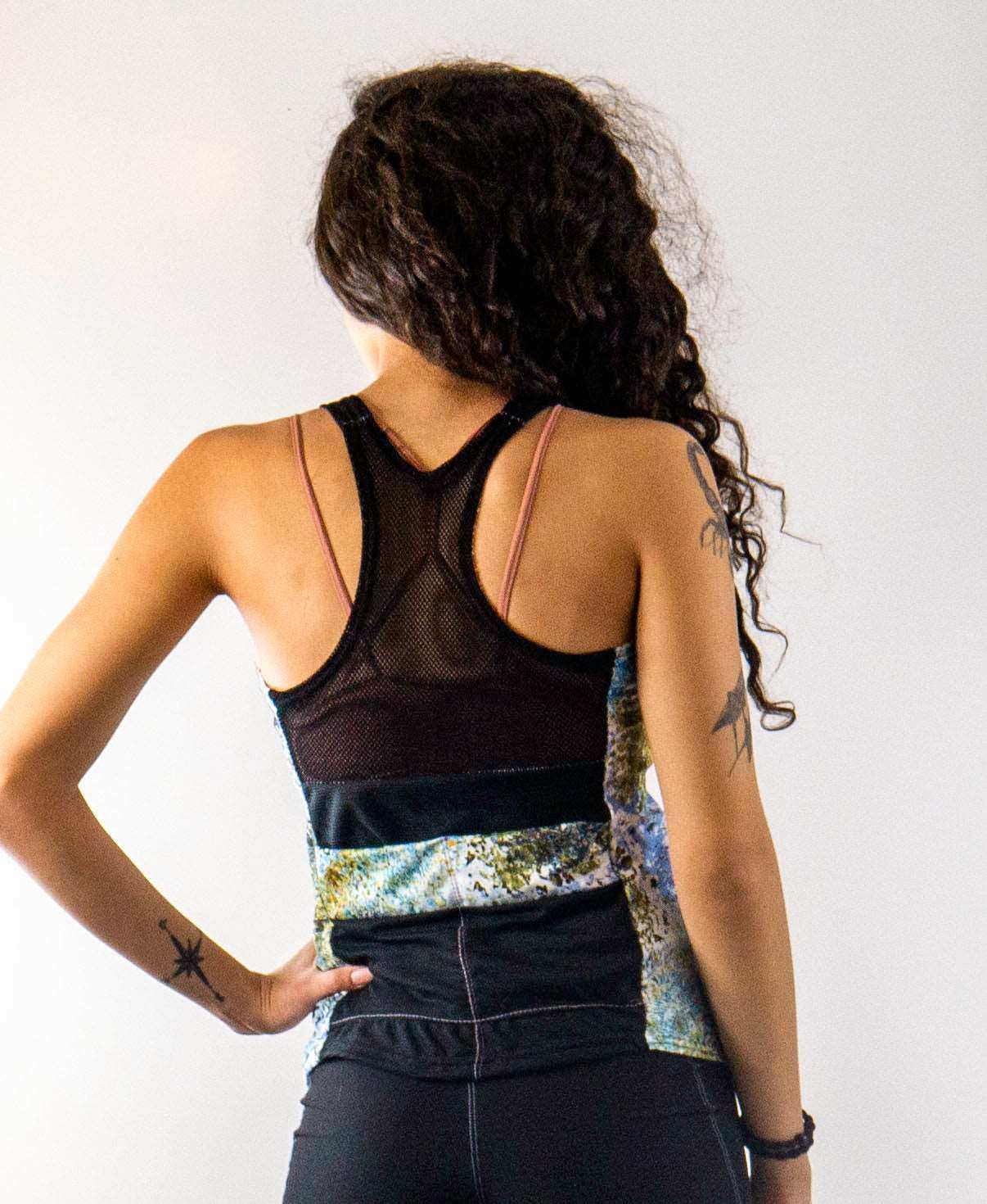Racerback Starlight tank with mesh back and vibrant design.