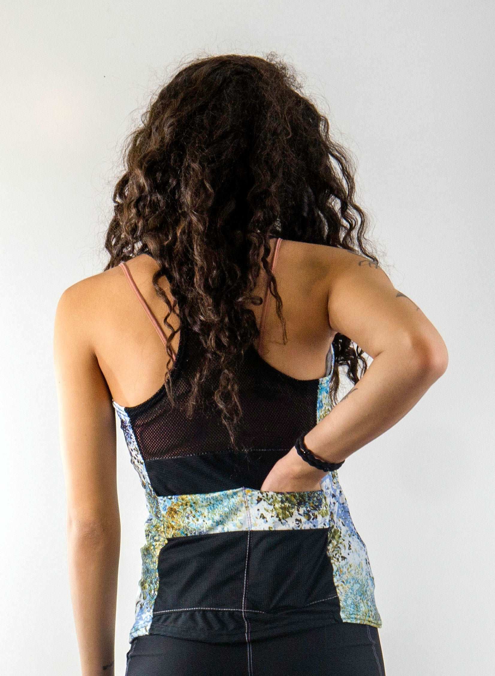 Racerback Starlight athletic top with mesh back detail and vibrant pattern design.