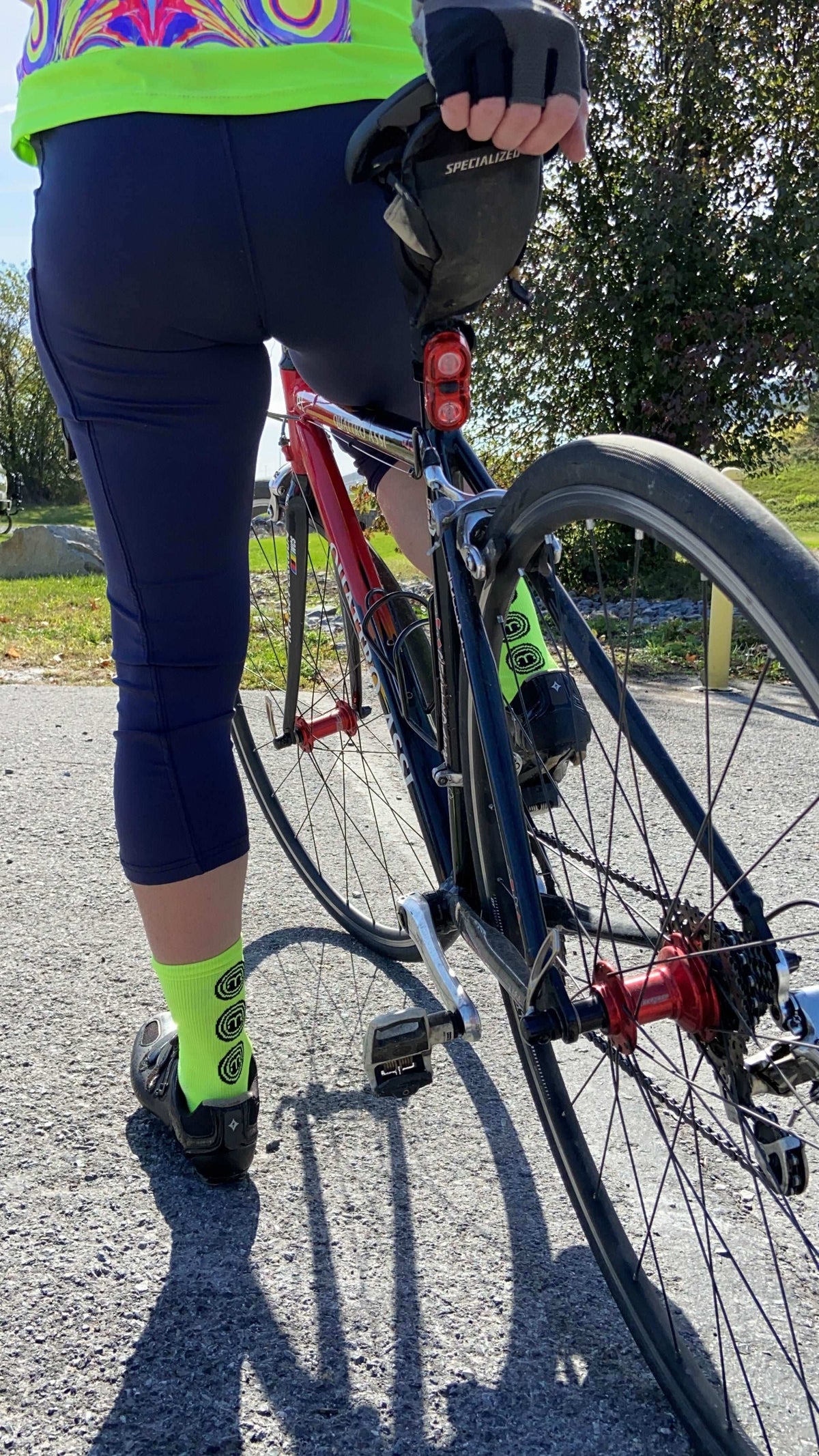 Cyclist wearing Moxie Socks - Moxie Yellow, featuring moisture-wicking fabric and 6-inch cuff.