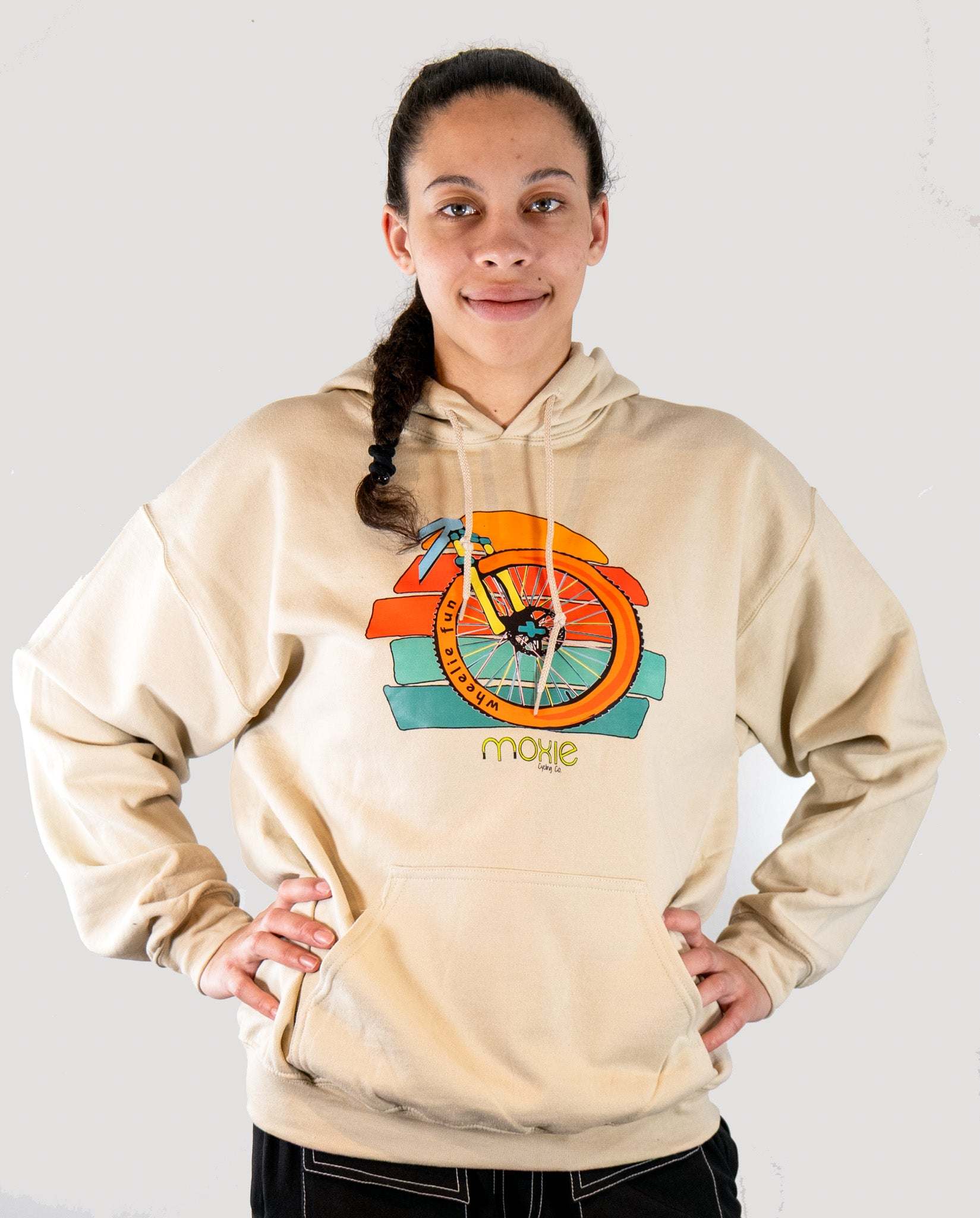 Person wearing a beige hoodie with a colorful graphic design on a white background
