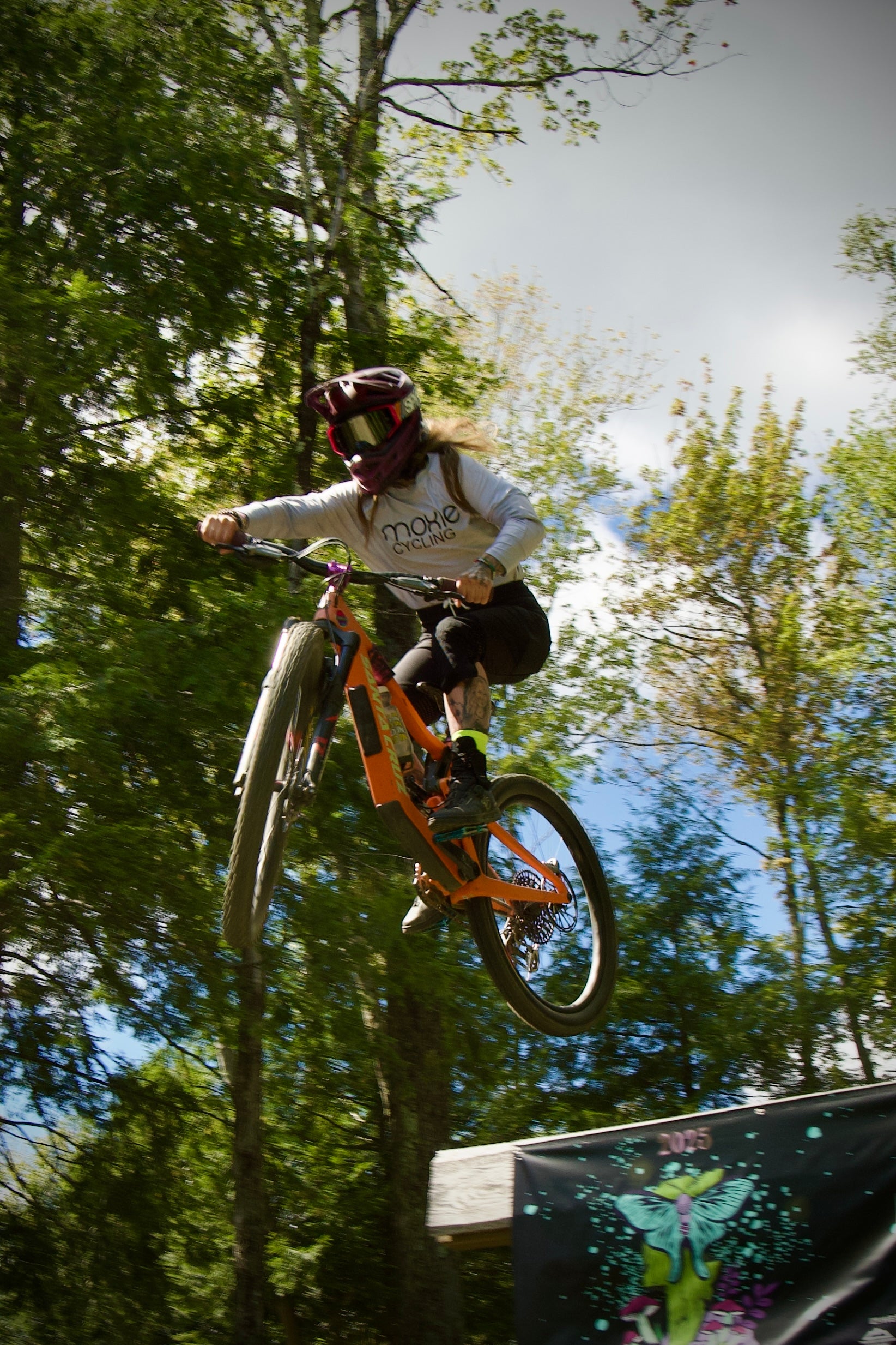 Moxie ambasador doing a jump on her bike wearing G-Form trail Pants