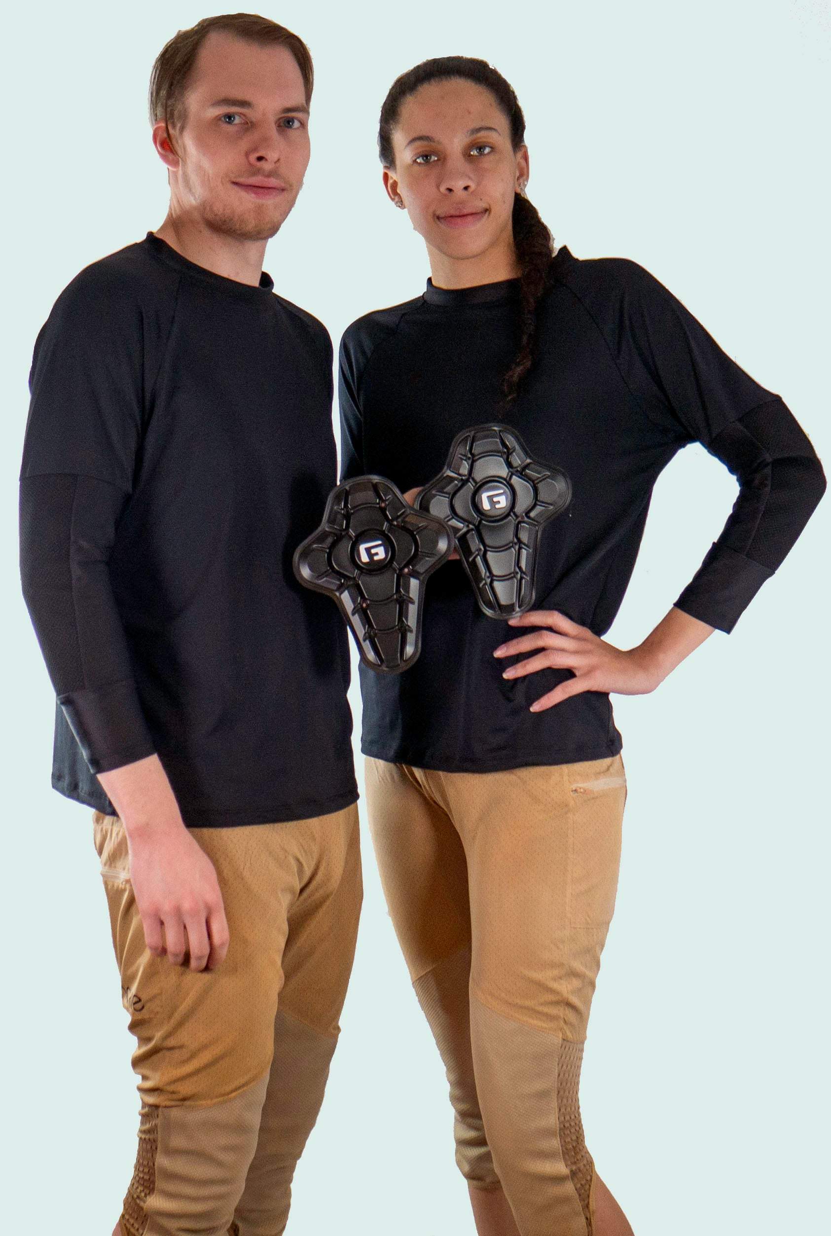 Bike pants with removable G-Form knee pads; worn by two models showcasing protective features.