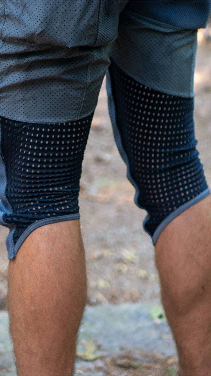 Bike pants with removable G-Form knee pads, black and white stripe design, featuring breathable mesh fabric.