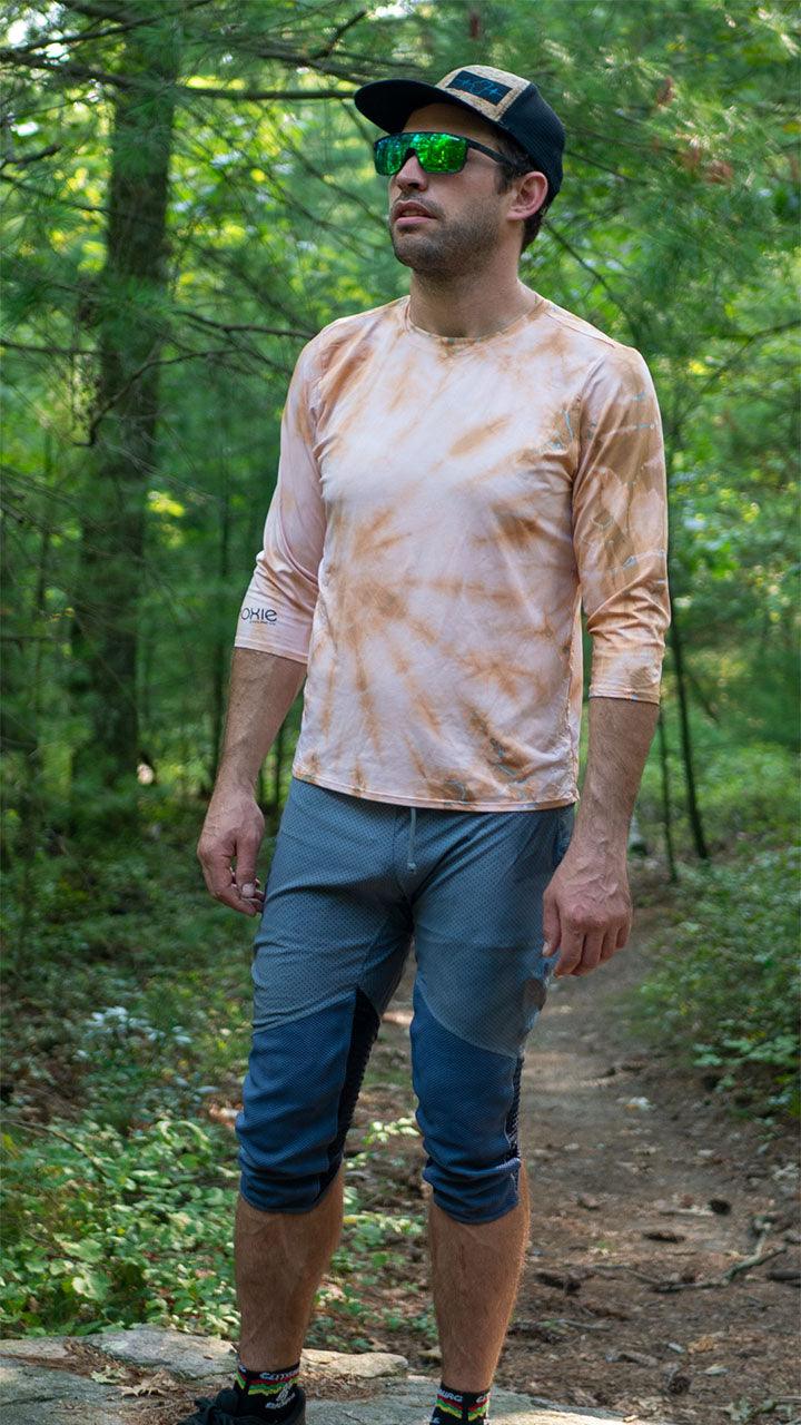 Bike pants with removable G-Form knee pads, black and white stripe, in forest setting.