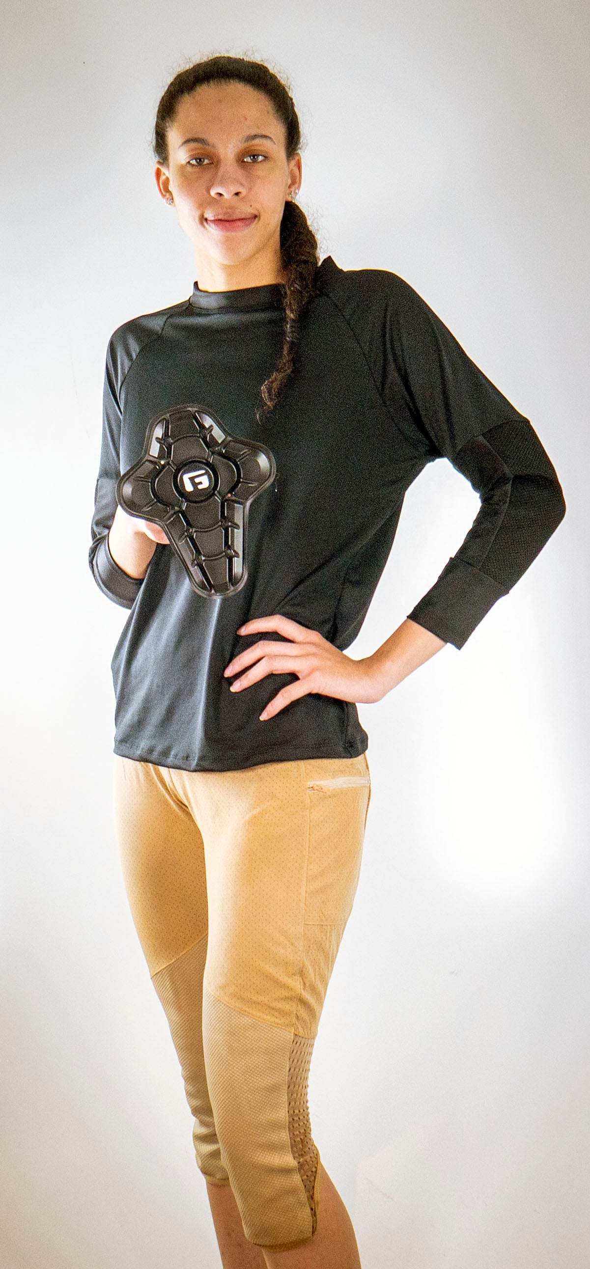 woman wearing black long sleeve shirt and tan women's mountain bike pants with removable G-Form hip and knee pads