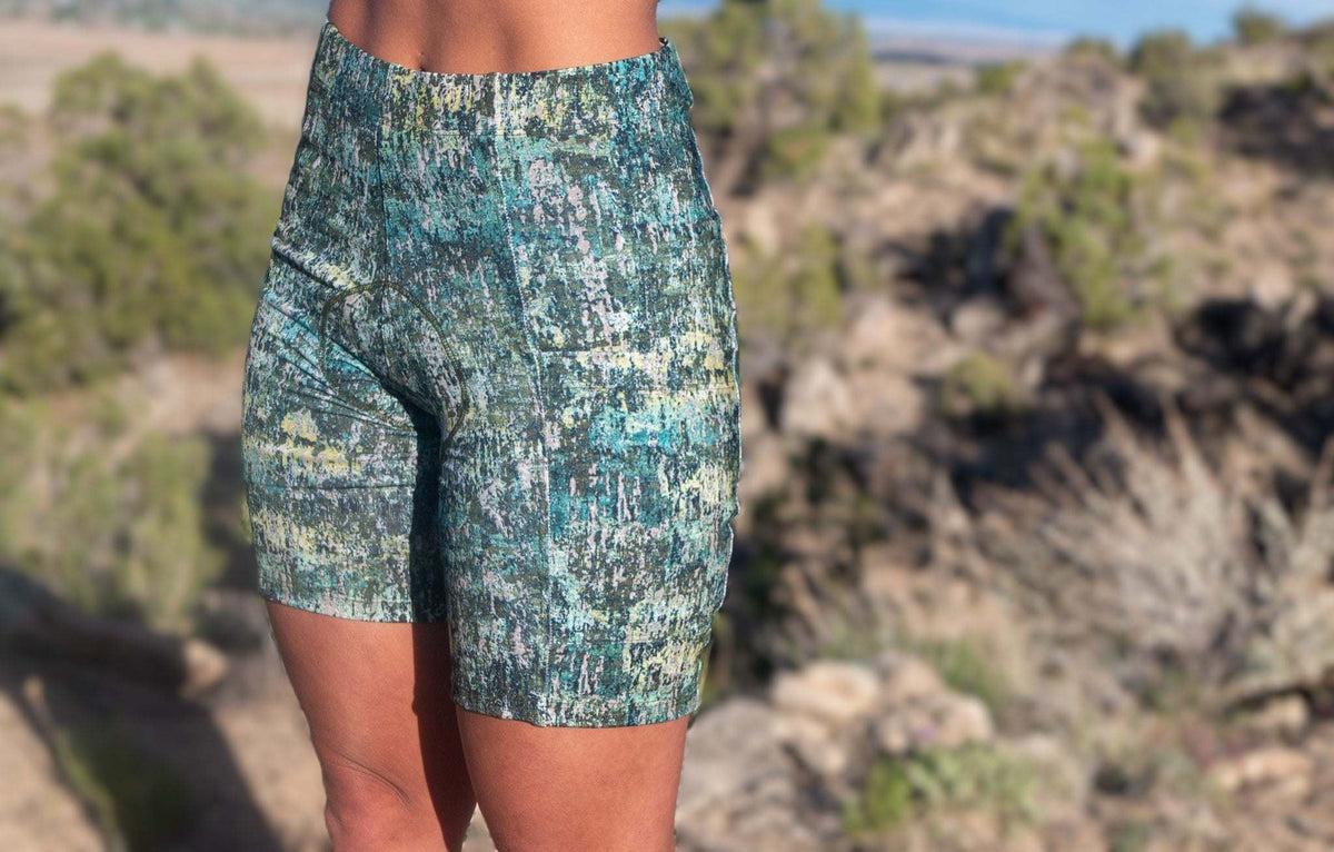 Women's gravel bike shorts with colorful pattern, designed for comfort and curves, featuring a sewn-in chamois and moisture-wicking fabric.