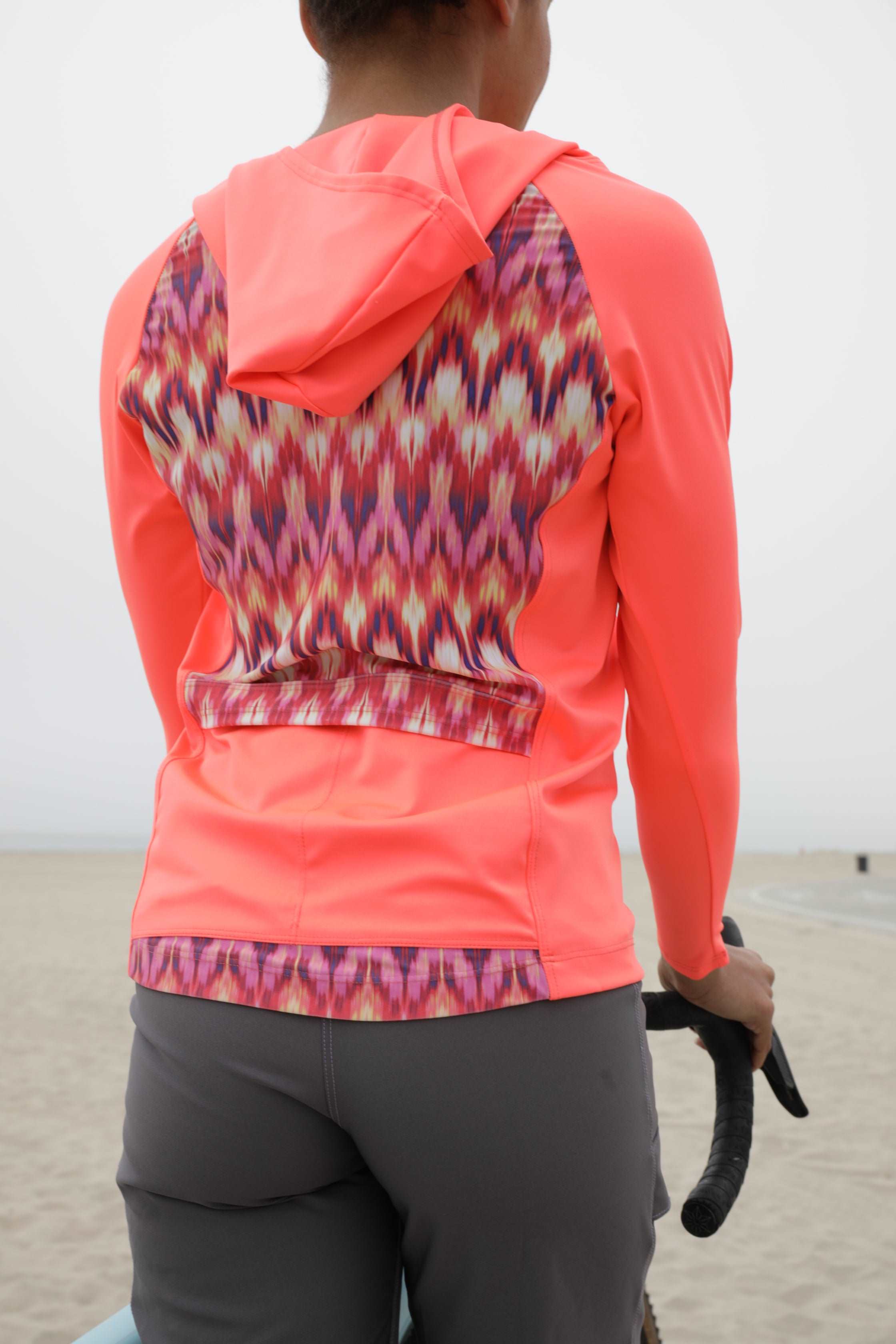 Moxie Tee Heavier Weight hoodie in bright color with patterned back, designed for biking.