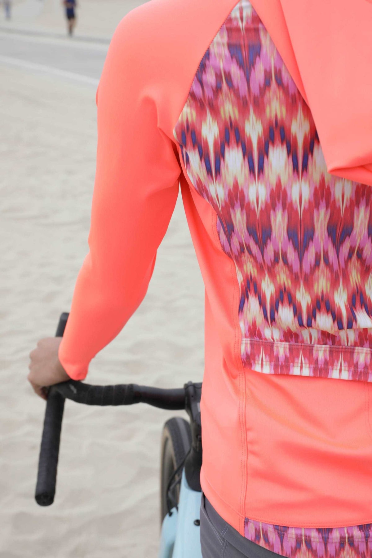 Moxie Tee Heavier Weight hoodie in vibrant colors, designed for cycling with moisture-wicking, breathable fabric, offering warmth and sun protection.