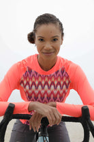 Moxie Tee Heavier Weight hoodie, long sleeve, high visibility, moisture-wicking fabric, woman on a bicycle.