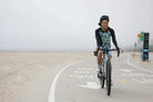 Moxie Hoodie High Visibility Color Wave for cycling on a coastal path.