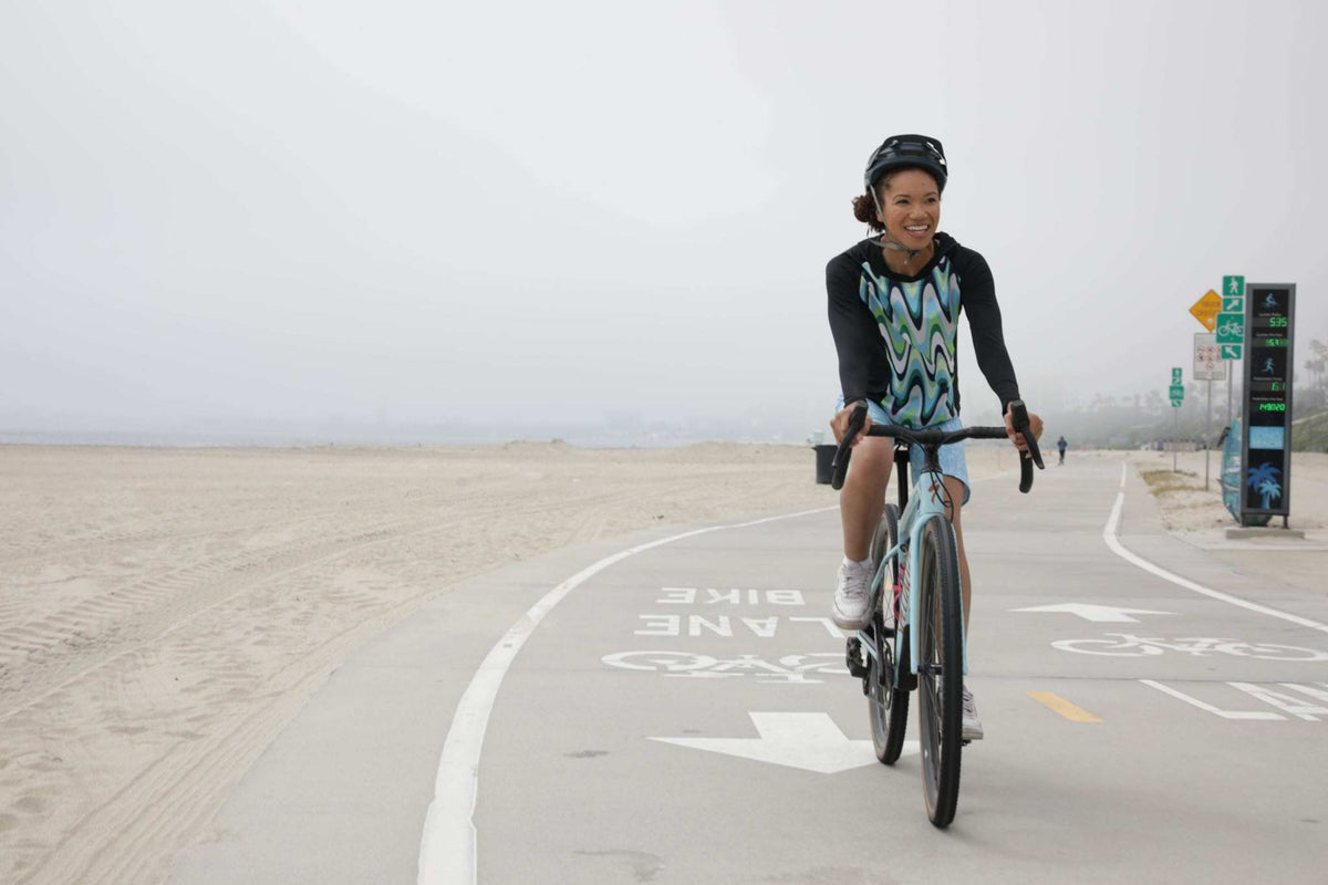 Moxie Hoodie High Visibility Color Wave for cycling on a coastal path.