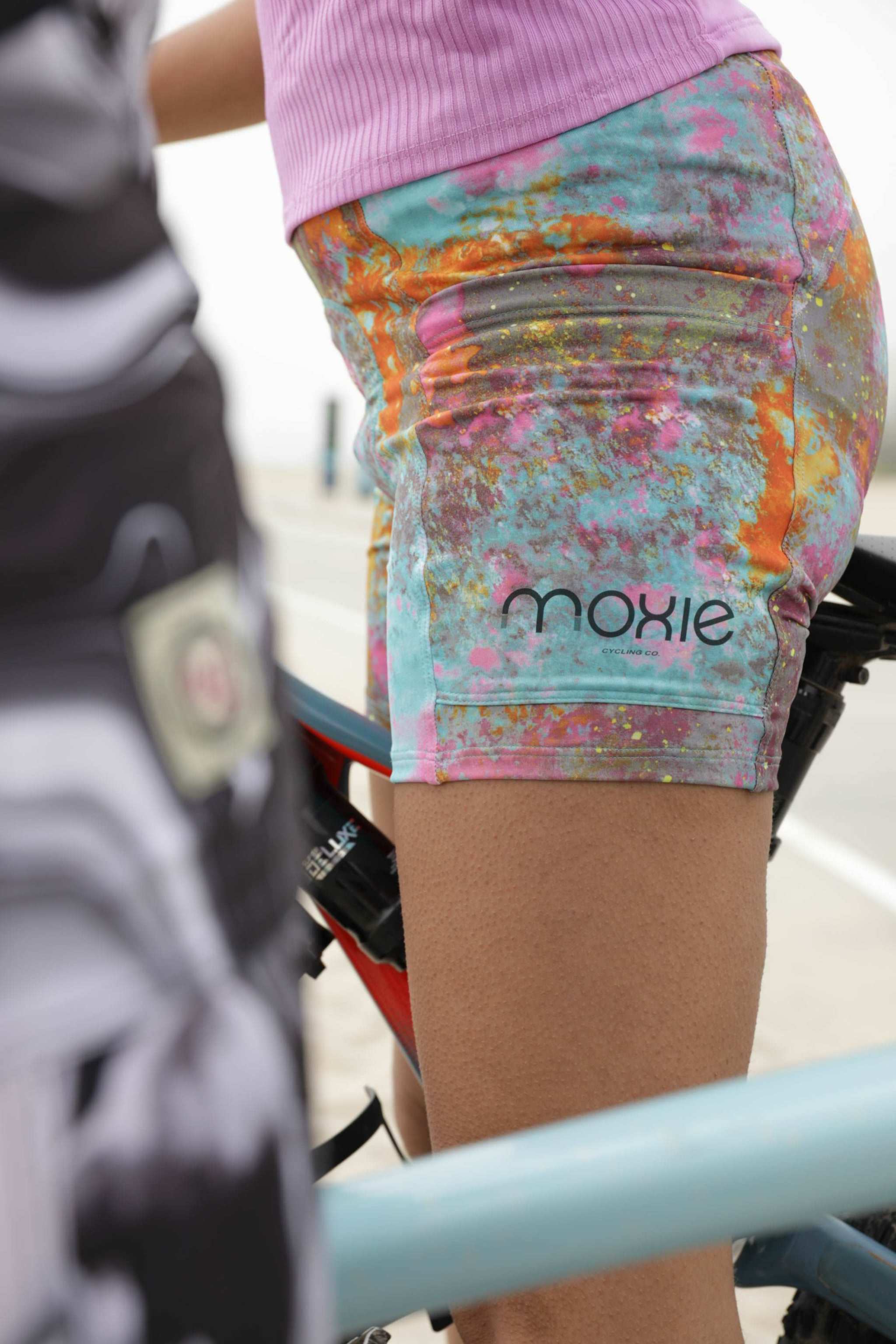 Women's gravel shorts with colorful design and performance chamois for cycling.