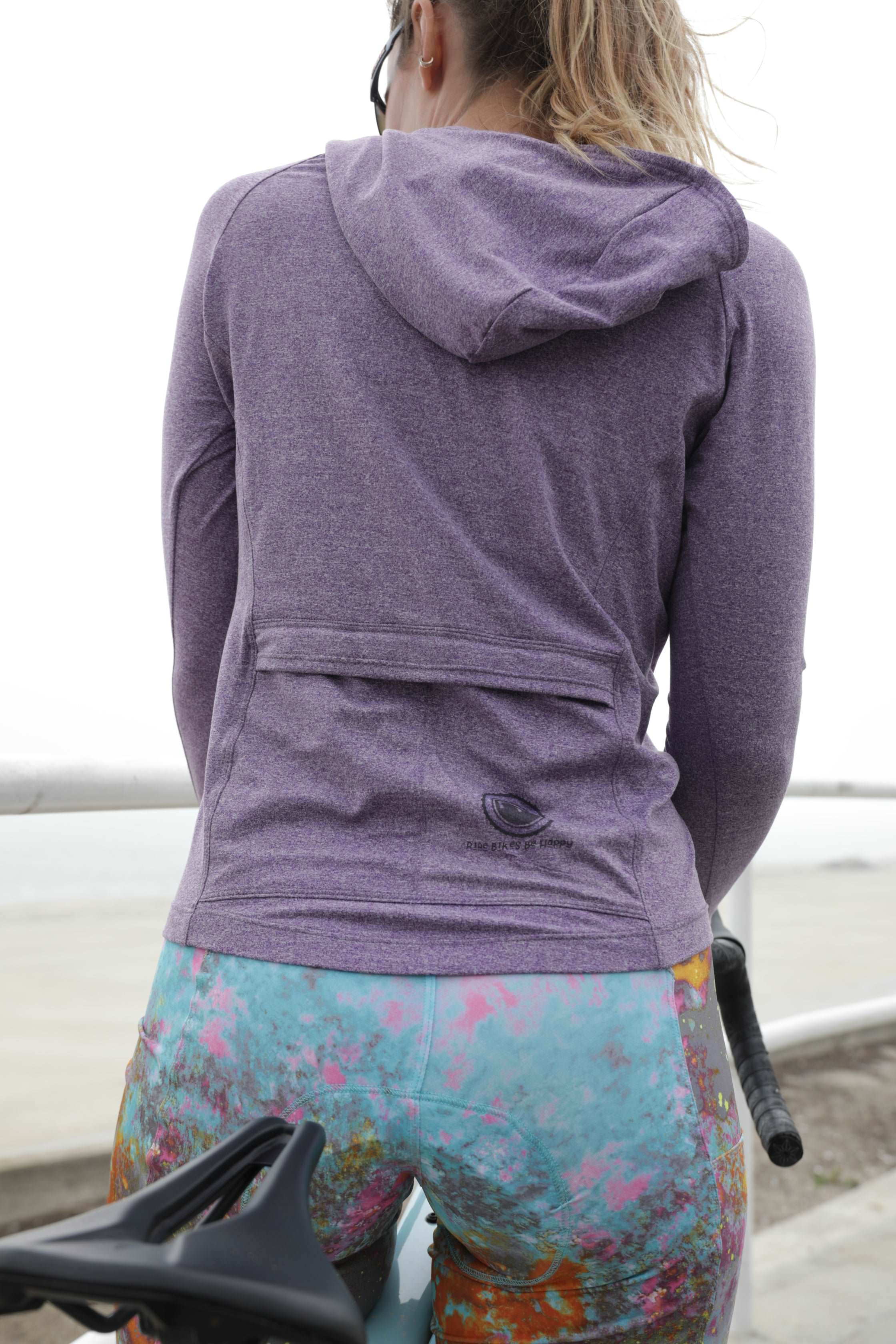 Moxie Hoodie Ride Bikes in purple with back pockets, perfect for cool weather cycling.