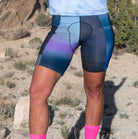 Women's bike shorts with 7" inseam, Italian chamois, and vibrant gradient colors worn outdoors.