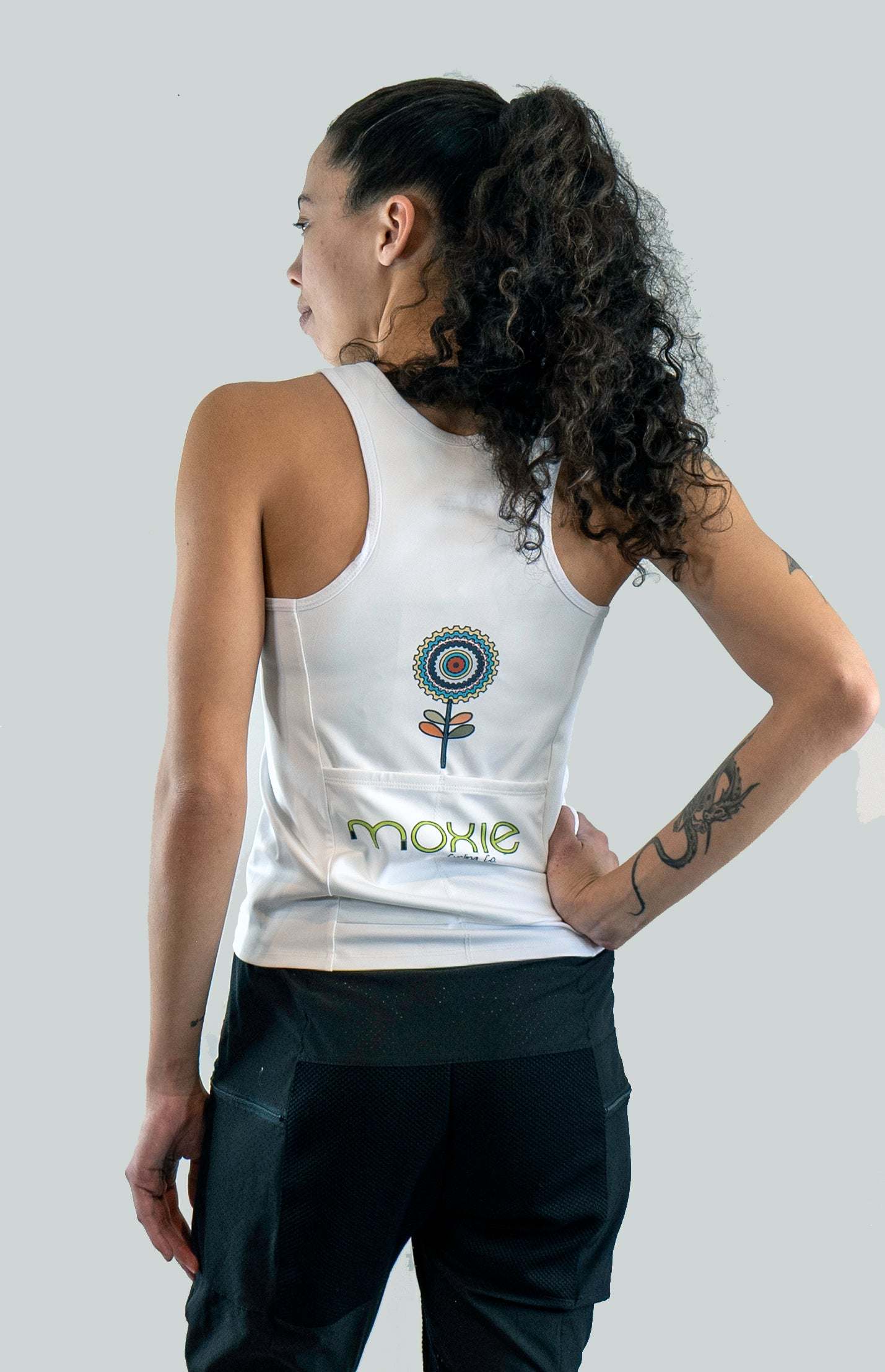 Women's sleeveless jersey in white.  Back view of 2 back pockets and graphics