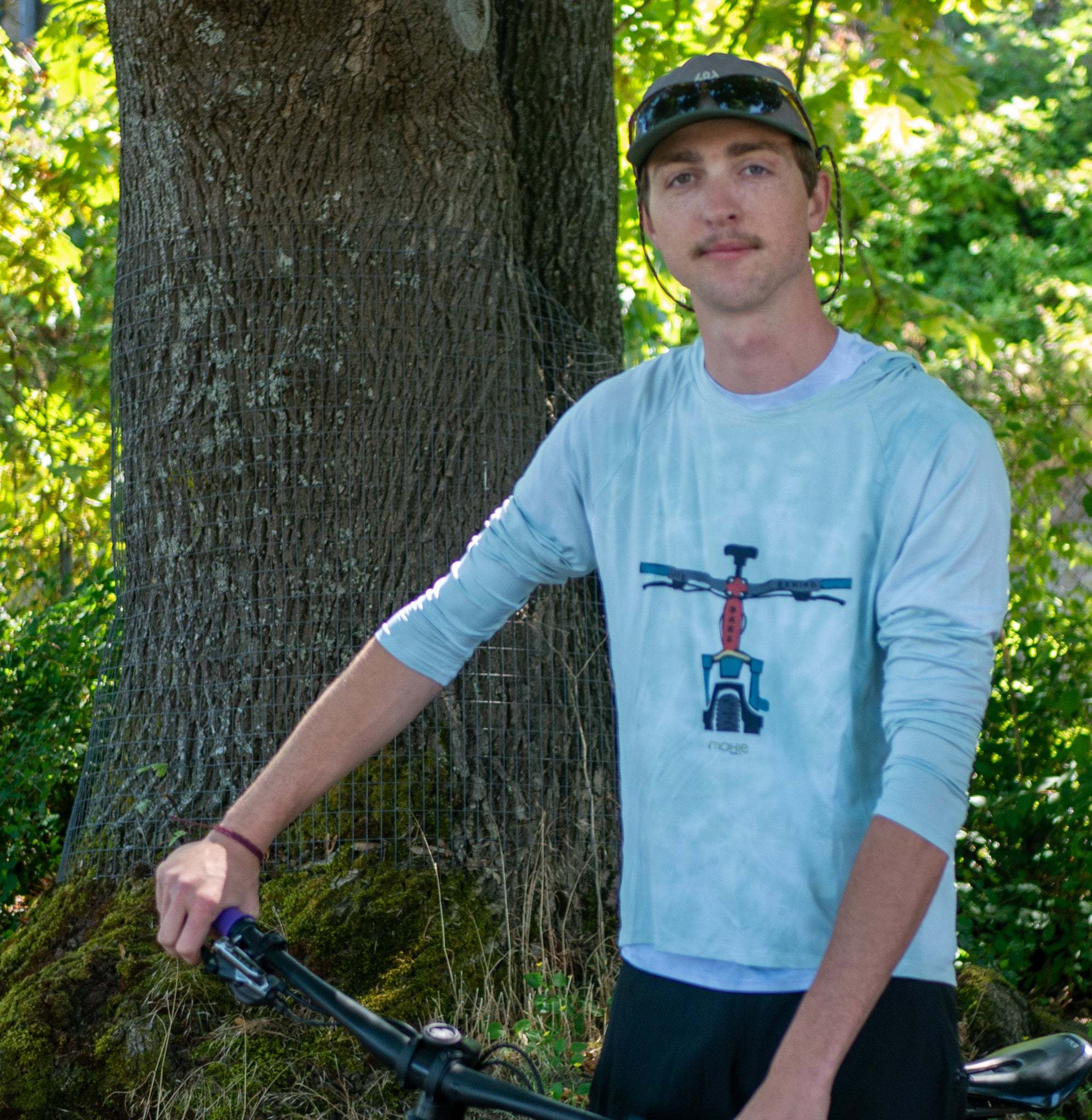 A man wearing cycling hoodie with 2 back pockets.