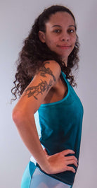Women's sleeveless bike jersey in teal, featuring breathable mesh fabric and back pocket.