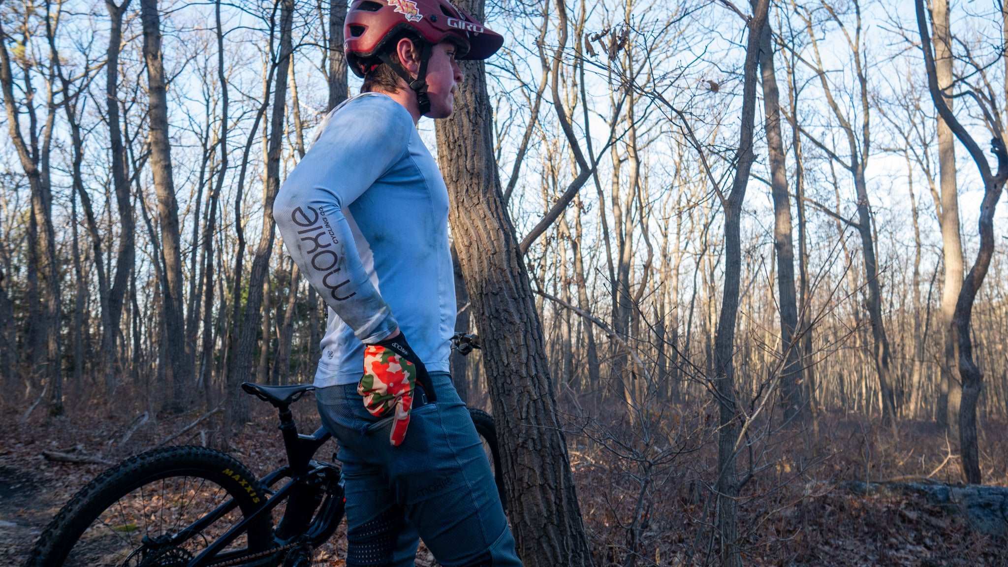 All Gender Hoodie in forest setting during a bike ride.