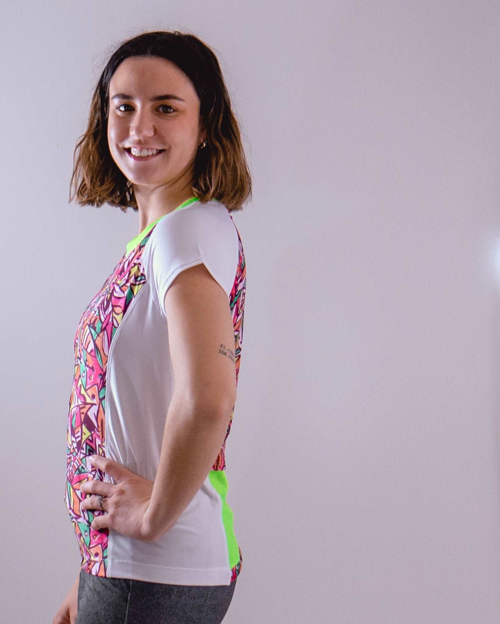 Woman wearing Moxie Tee Jersey Fifi with colorful pattern and short sleeves.