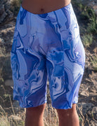 Steezy Stretch Bike Shorts Steel Flowers with blue abstract pattern, featuring contoured cut, moisture-wicking fabric, and large side pocket.