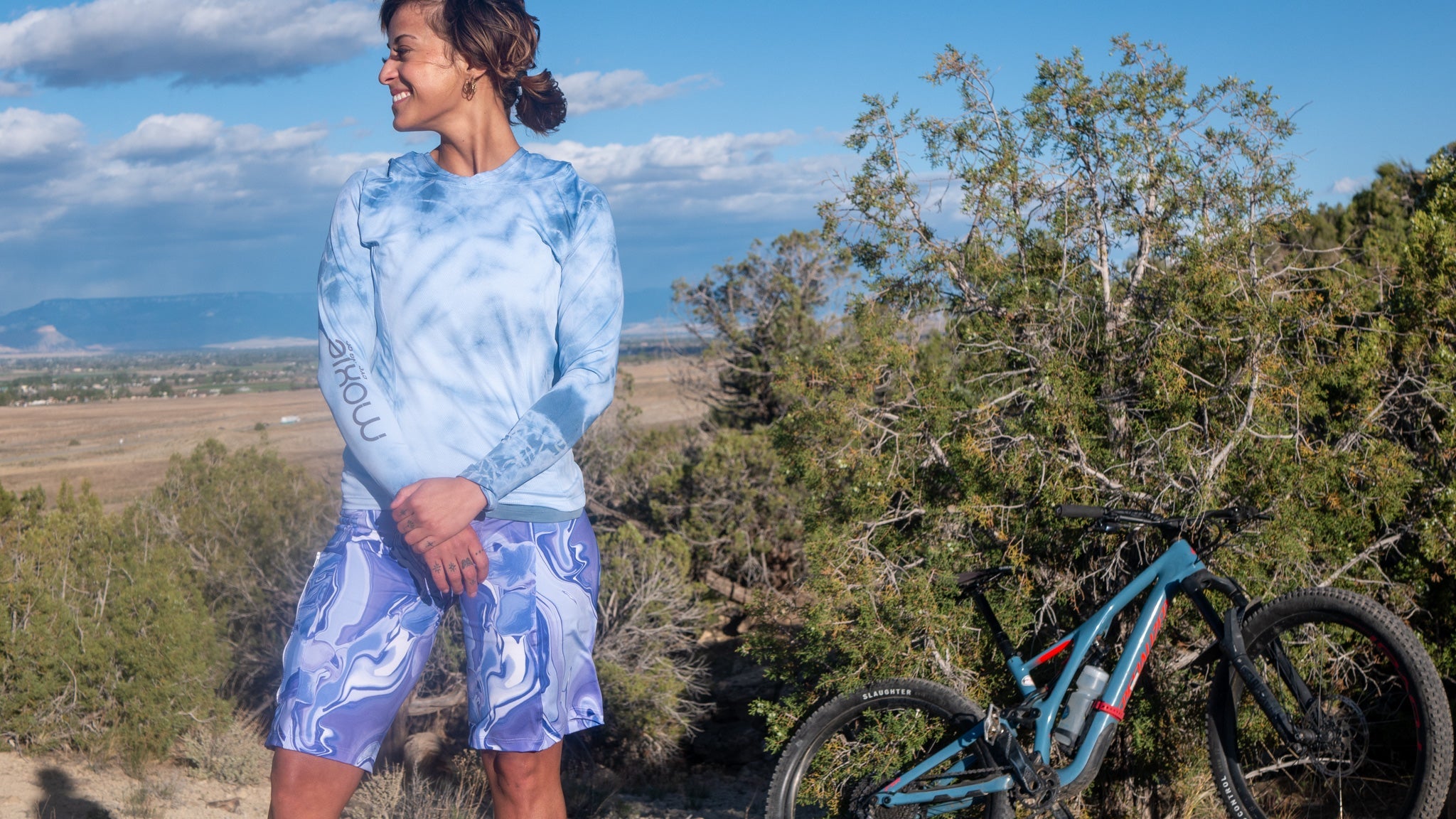 Women's wearing Steezy Stretch Bike Shorts Steel Flowers, modeling outdoor in bike apparel.