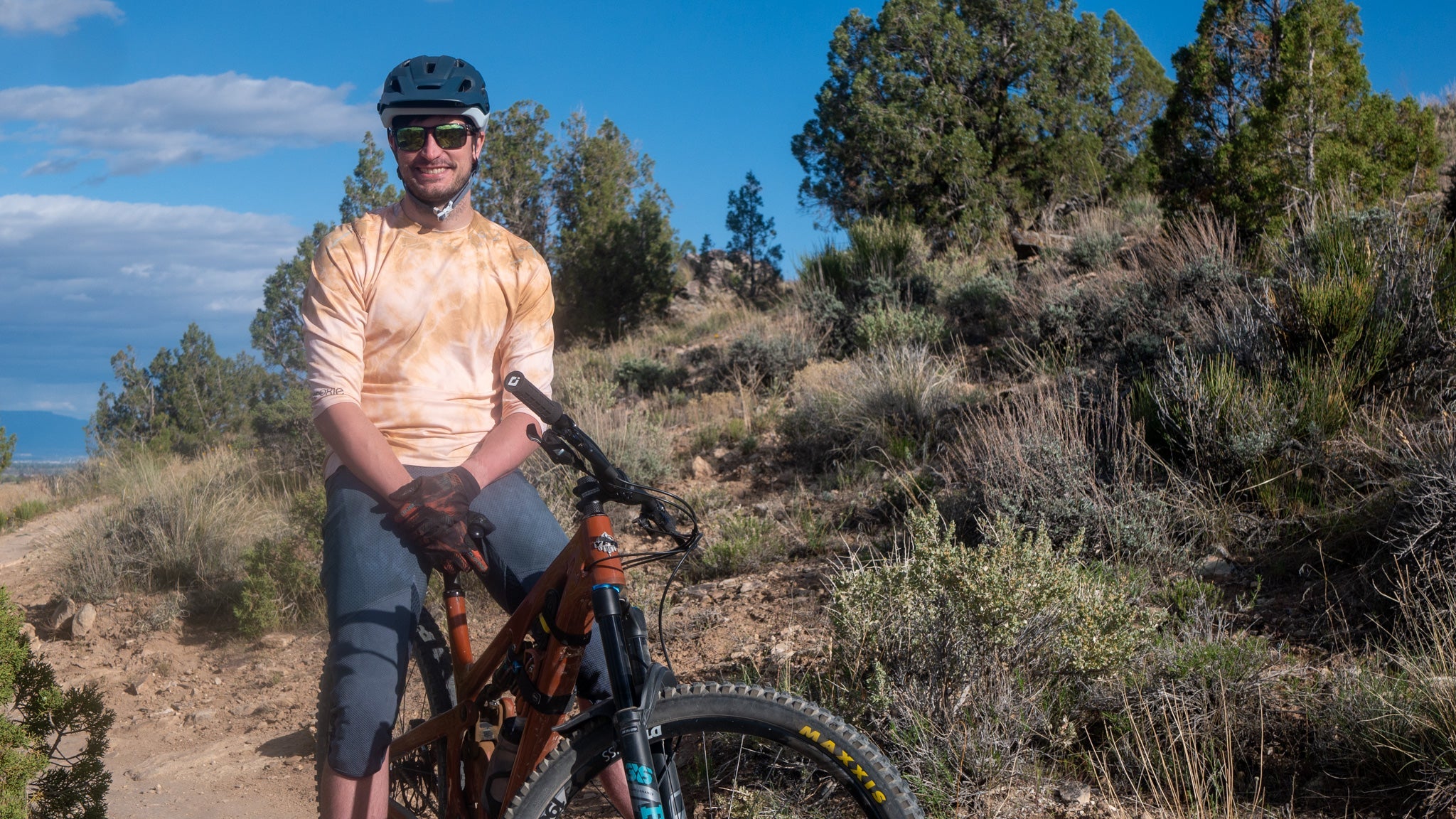 All Gender Jersey for mountain biking in soft mesh fabric, worn by cyclist on trail.