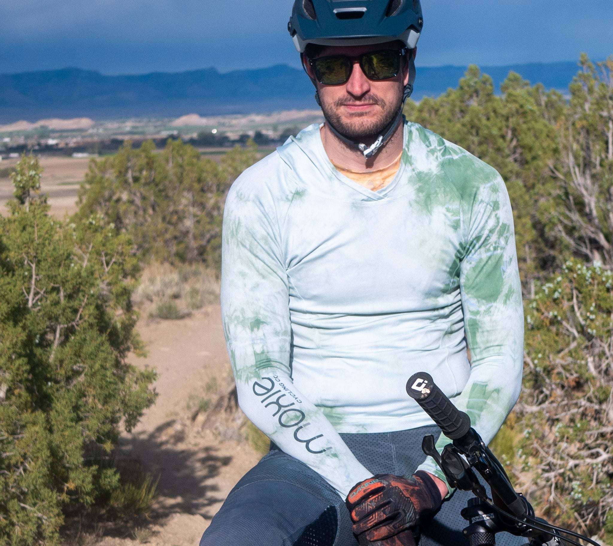 All Gender Hoodie designed for comfort and performance, featuring moisture-wicking fabric, worn by a bike rider outdoors.