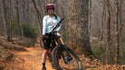Moxie Sun Saver Hoodie worn by cyclist in forest trail.