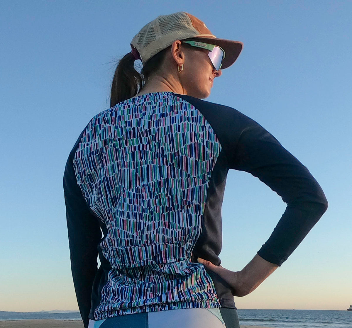 Moxie Tee Jersey Blues Long Sleeve with Purple Paisley design, featuring moisture management technology for endurance on bike rides.