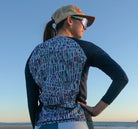 Moxie Tee Jersey Blues Long Sleeve with Purple Paisley design, featuring moisture management technology for endurance on bike rides.