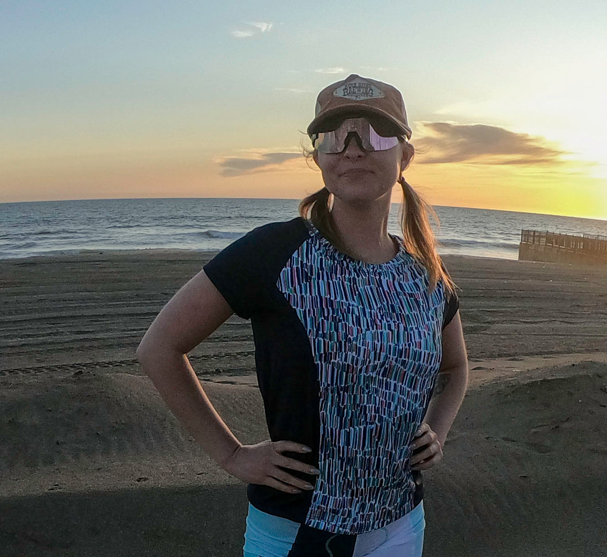 Moxie Tee Jersey Blues Long Sleeve in Purple Paisley design, worn by the beach at sunset.