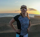 Moxie Tee Jersey Blues Long Sleeve in Purple Paisley design, worn by the beach at sunset.
