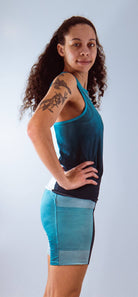 Women's bike shorts with 7" inseam and Italian chamois, featuring a blue gradient design, worn by a model.