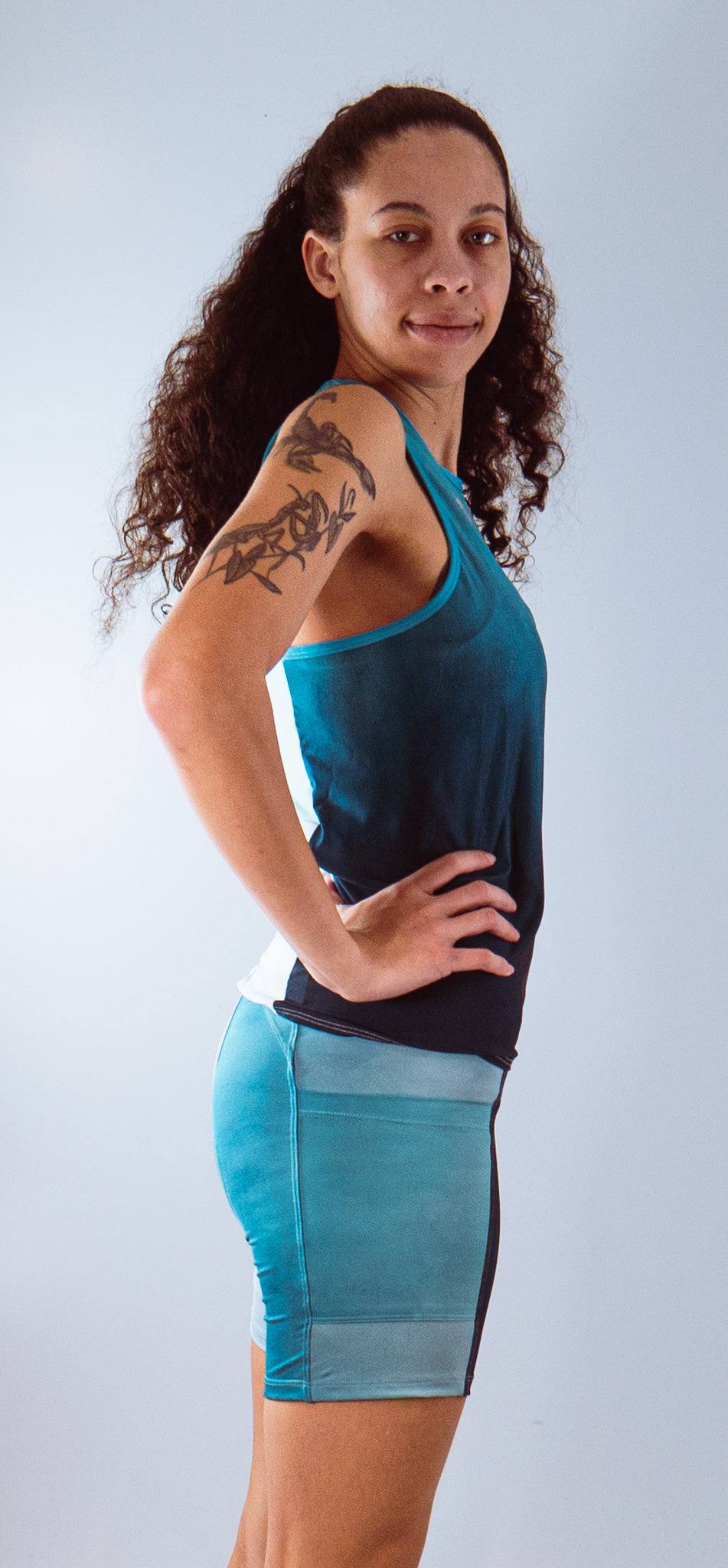 Women's bike shorts with 7" inseam and Italian chamois, featuring a blue gradient design, worn by a model.