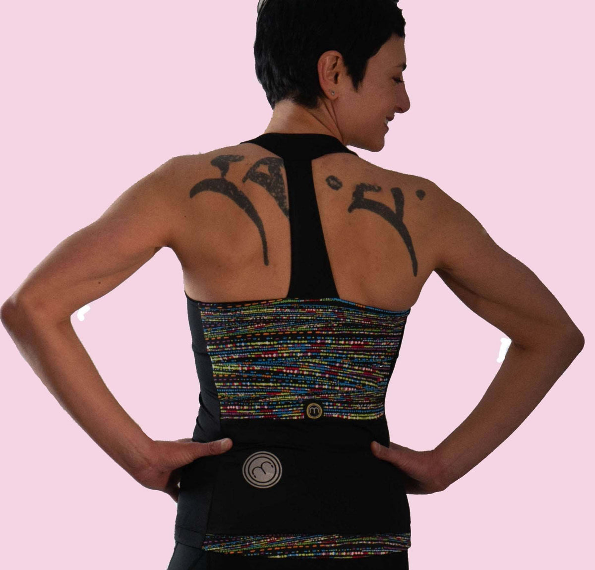 High Visibility Cycling Top with T-back design and colorful print, featuring strategic ventilation and oversized pockets.