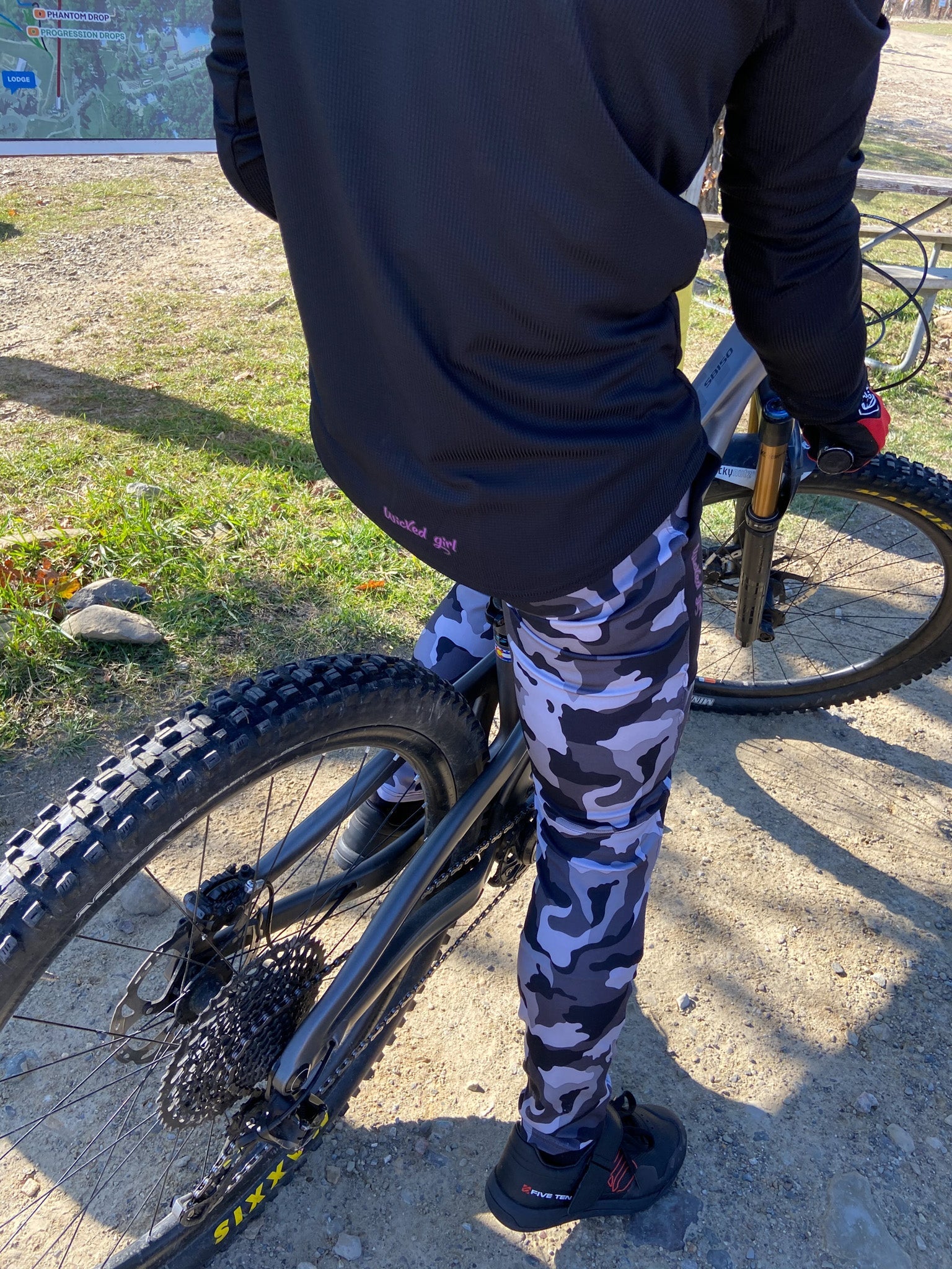 Bike Cycling Pants in black and white camo pattern worn by a cyclist on a trail.