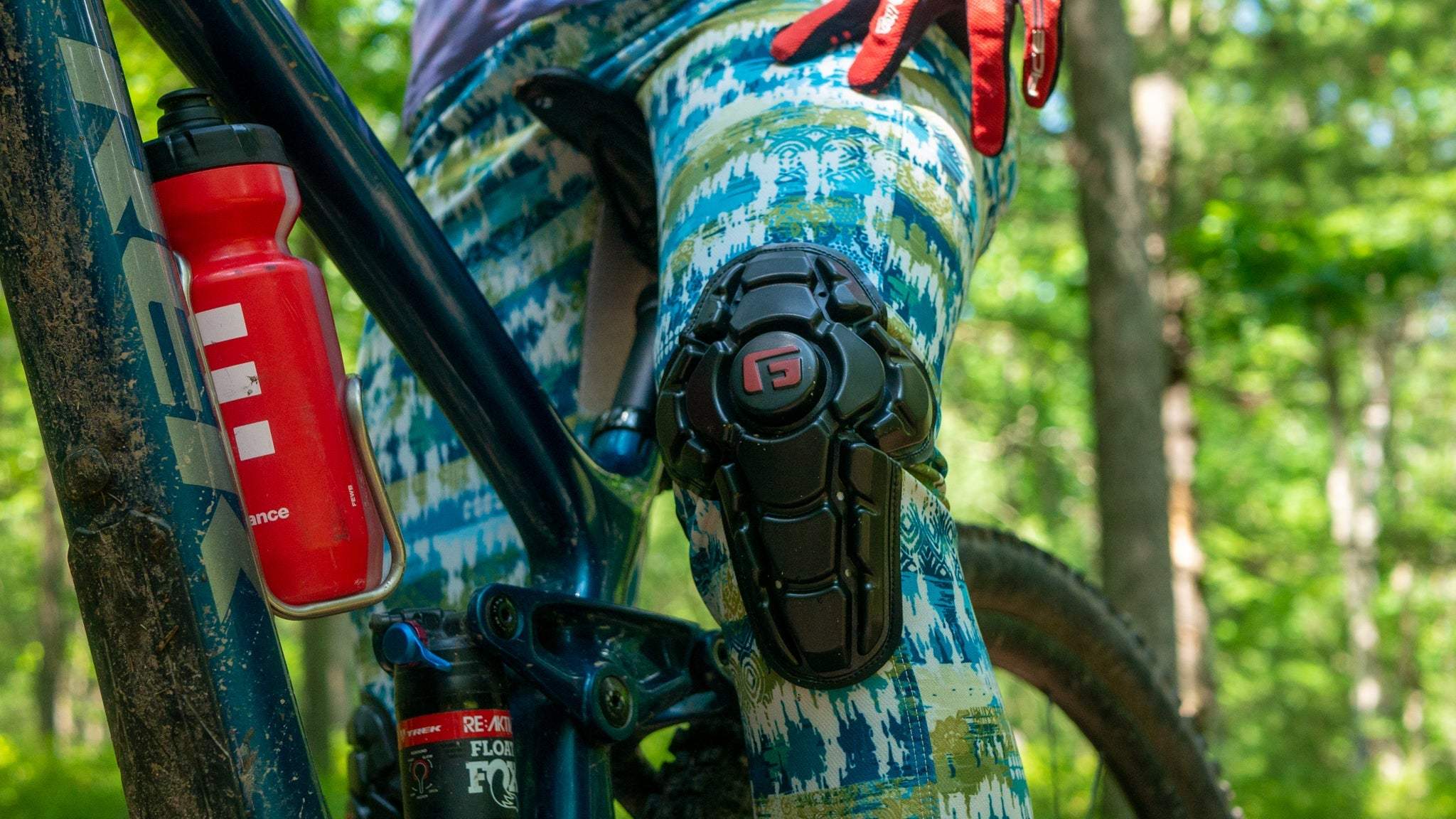 Bike pants with G-Form knee pads in boho pattern, perfect for female cyclists on trails.