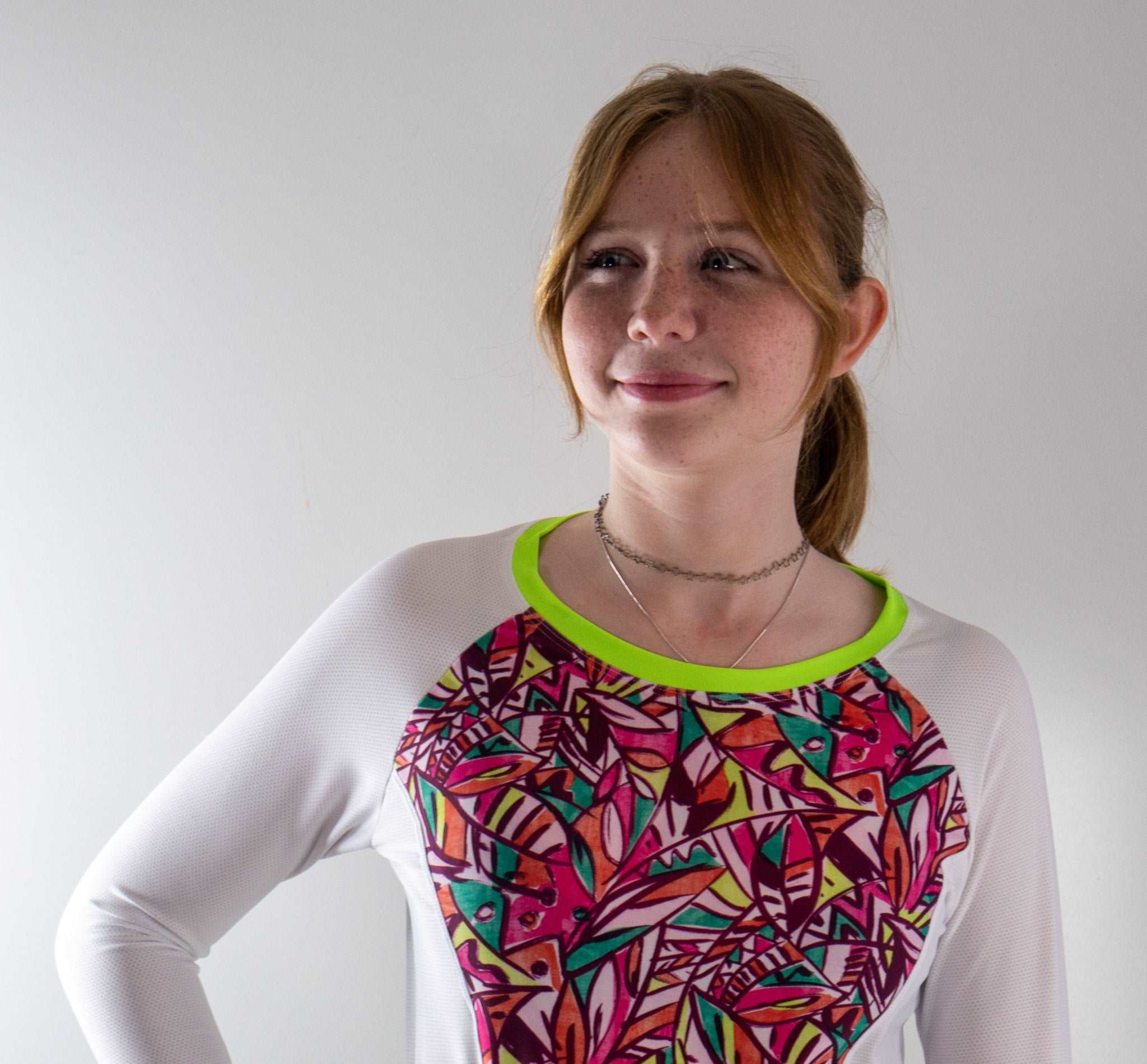 Moxie Tee Jersey High Visibility Fifi with vibrant patterned design, featuring long sleeves and moisture-wicking fabric.