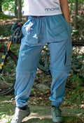 Women's mountain bike pants in dusty blue with cargo pockets and gusseted construction for comfort and versatility