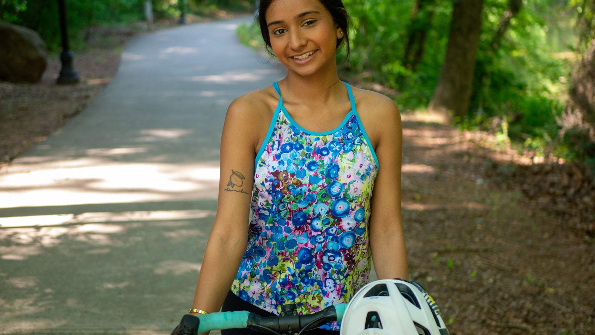 Women's sleeveless cycling jersey Tailwind Tank with floral design, moisture-wicking fabric, high neckline, and back pockets for mountain and gravel biking