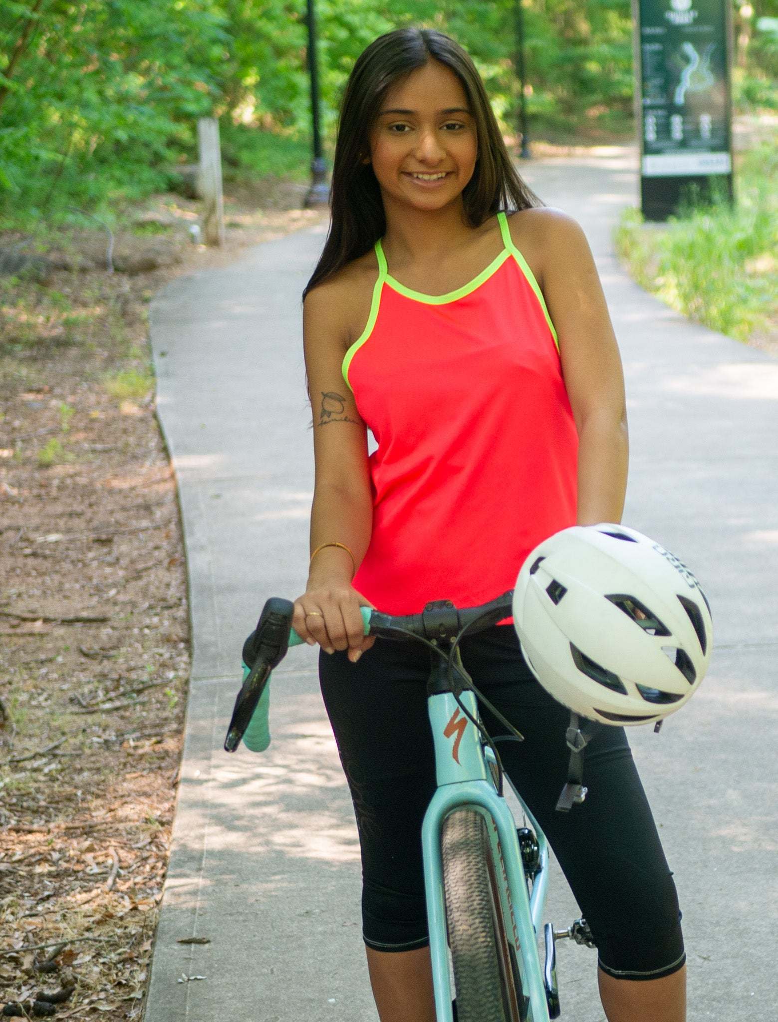 Women wearing sleeveless high-visibility bike jersey with breathable fabric and back pocket for cycling