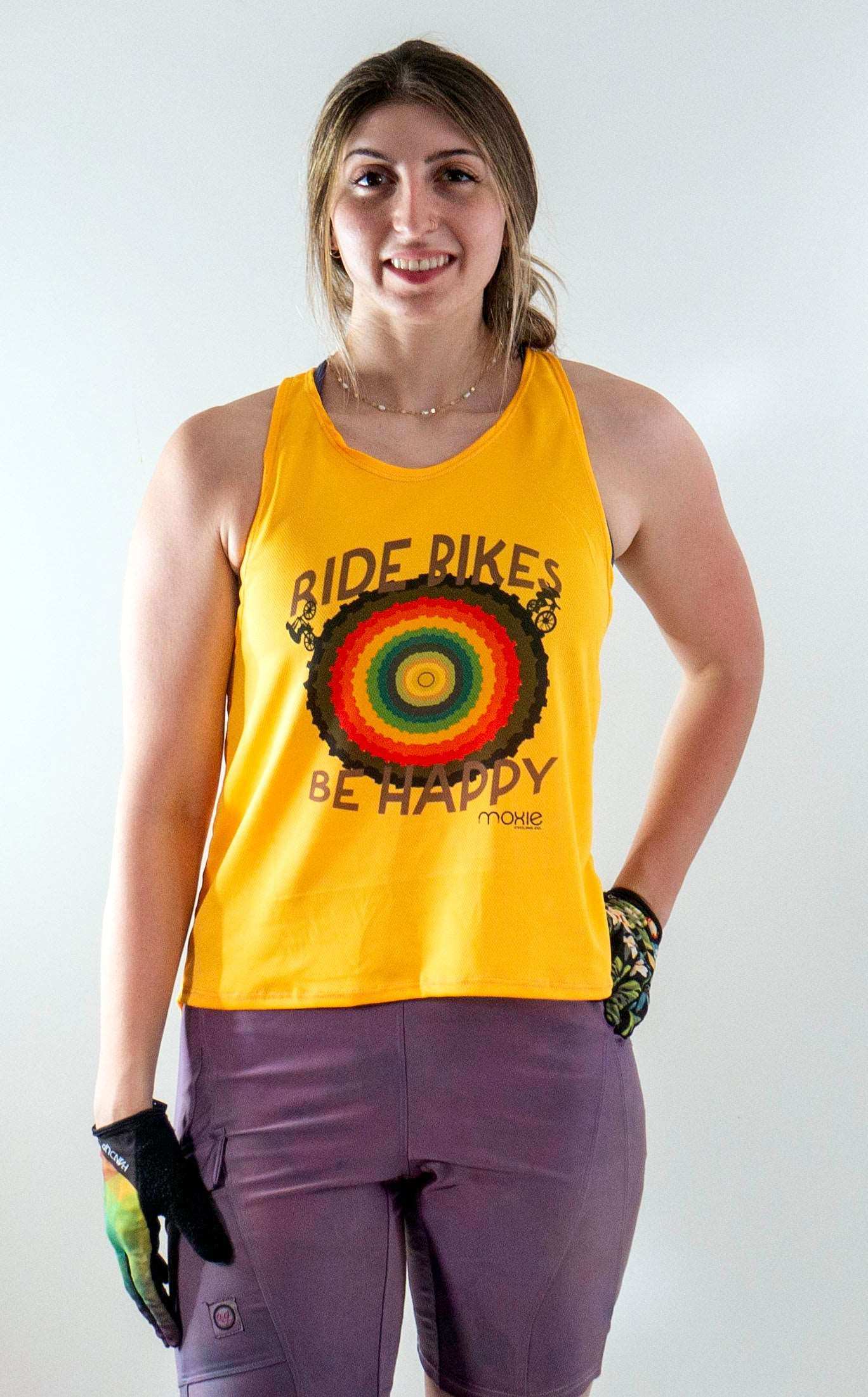 Yellow "Ride Bikes Be Happy" tank top with rainbow design, featuring a light mesh fabric for breathability, ideal for mountain biking.