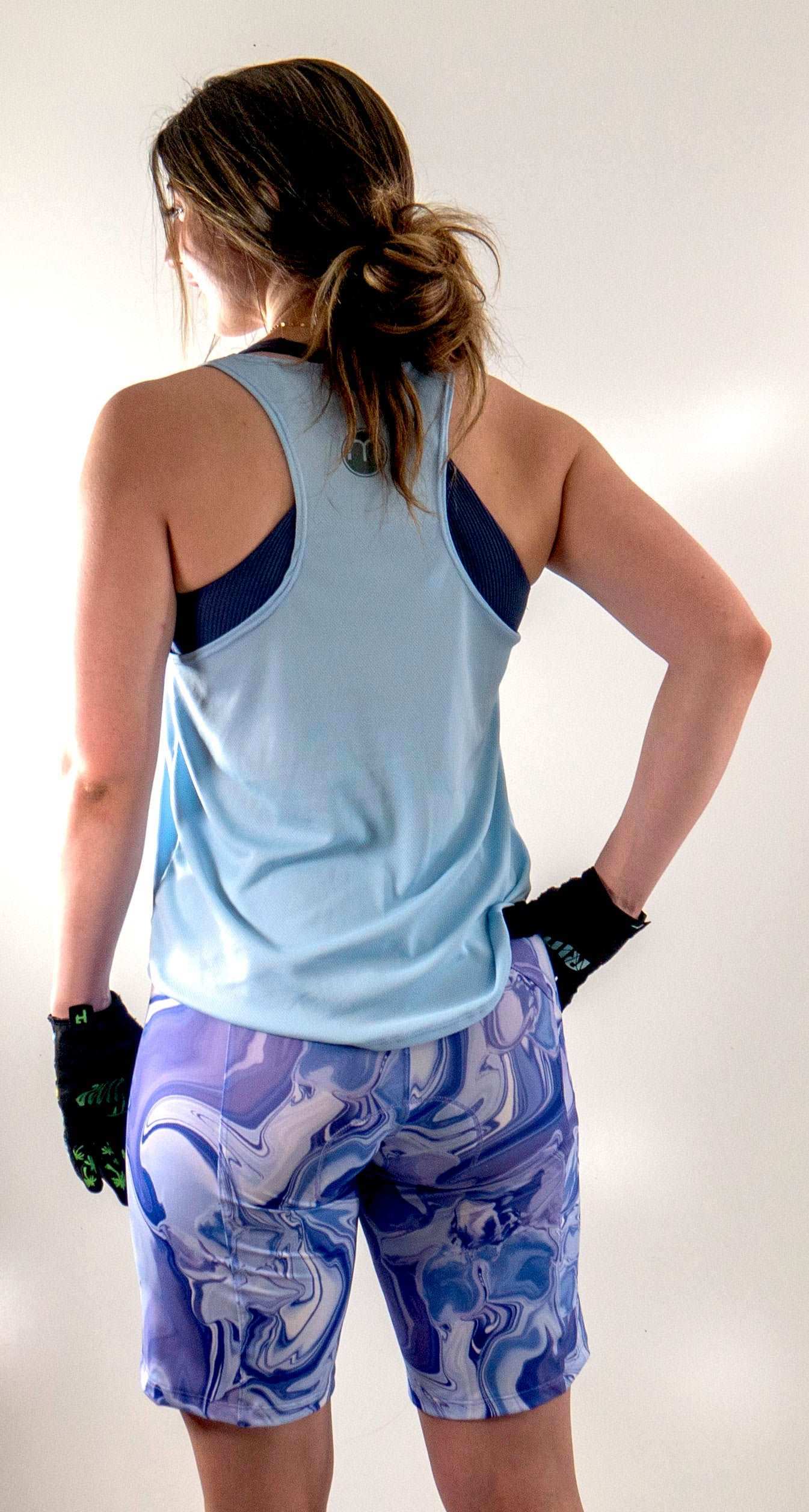 Light blue 'Ride Bikes Be Happy' tank for mountain biking, featuring breathable mesh fabric and a loose fit.