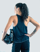 Woman wearing Moxie Tech Tank breathable mesh cycling jersey with Ride Bikes Be Happy graphic