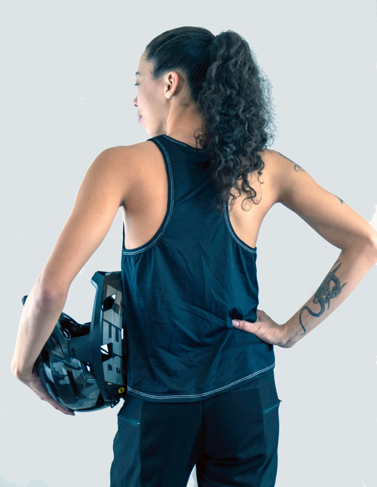Woman wearing Moxie Tech Tank breathable mesh cycling jersey with Ride Bikes Be Happy graphic
